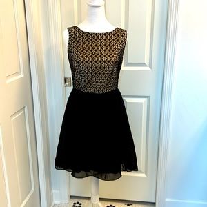 Black lace cocktail dress. High/low skirt. Size small.